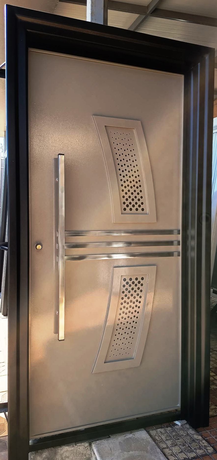 Close-up of lock and hinge hardware on the security door