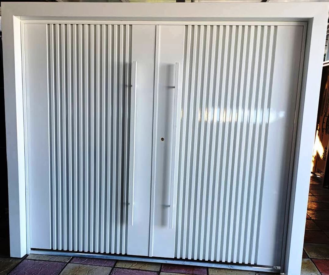 Swing garage door installed at a car driveway entrance